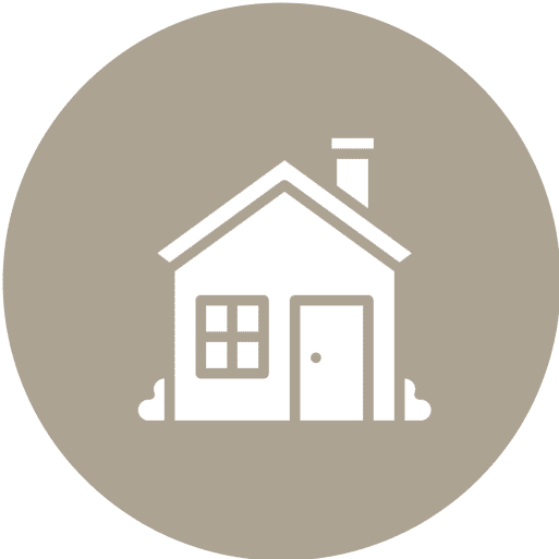 Simple white icon of a house with a door, window, and chimney, centered on a light brown circular background.